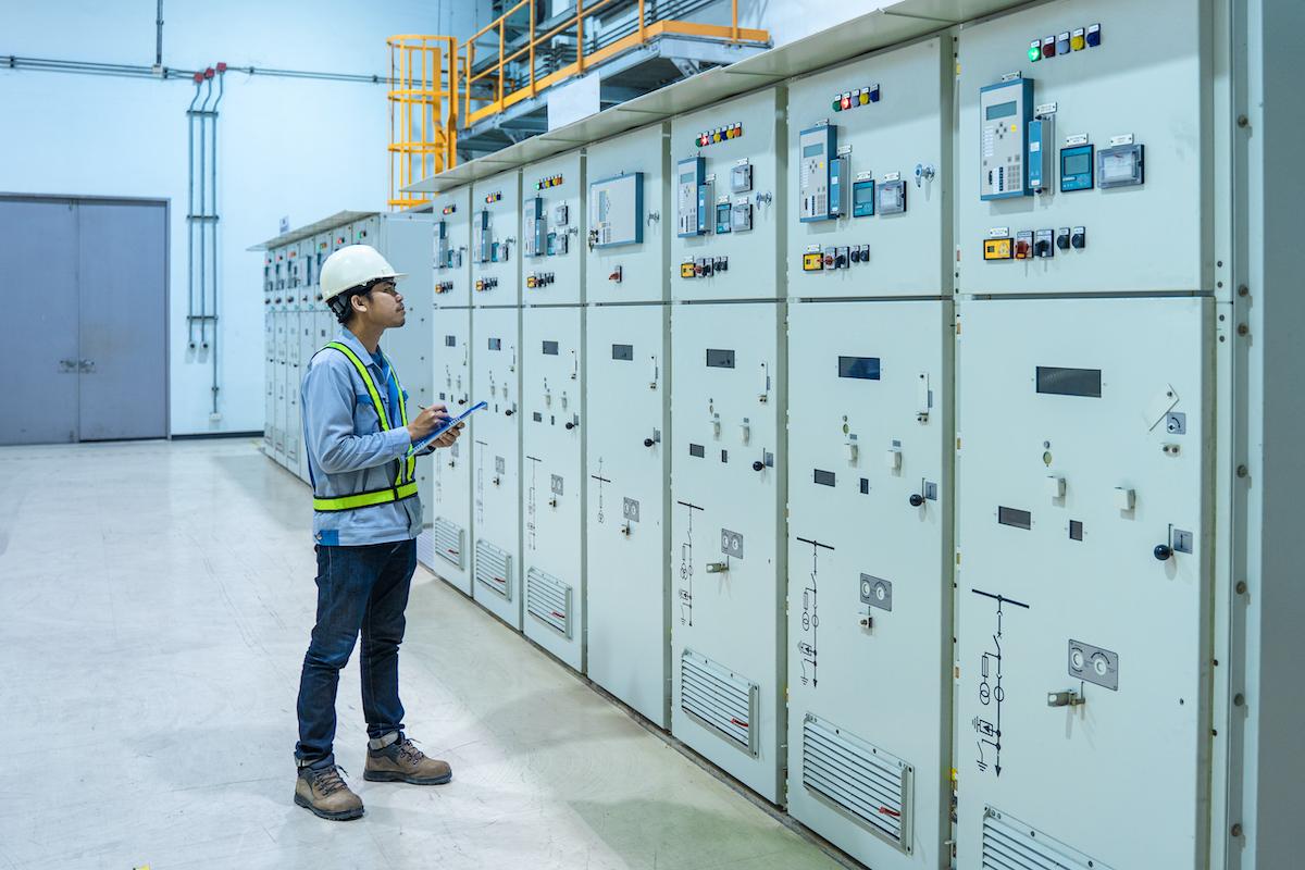 Electrical engineer inspecting industrial power systems